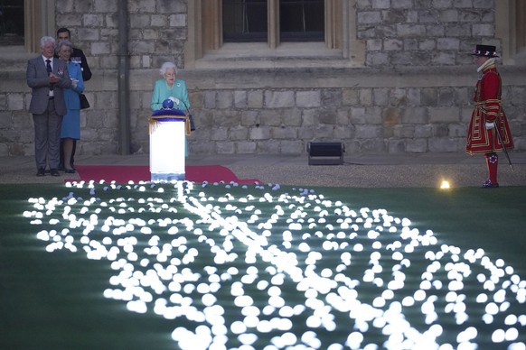 Britain&#039;s Queen Elizabeth II symbolically leads the lighting of the principal Jubilee beacon at Windsor Castle, Windsor, England, Thursday June 2, 2022, on day one of the Platinum Jubilee celebra ...