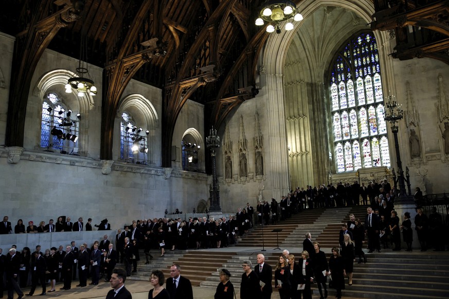 People queue to pay respect to the coffin of Britain's Queen Elizabeth II after the procession arrived at Westminster Hall from Buckingham Palace for her lying in state, in London, Britain, Wedne ...