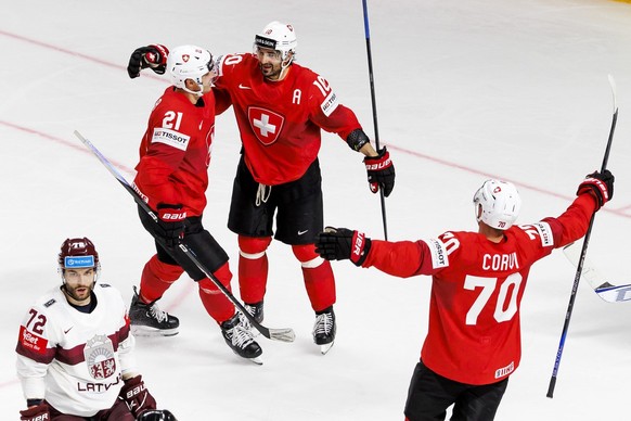 Switzerland&#039;s forward Andres Ambuehl #10 celebrates his goal with his teammates Switzerland&#039;s forward Kevin Fiala #21 and Switzerland&#039;s forward Enzo Corvi #70 after scoring the 3:2, dur ...