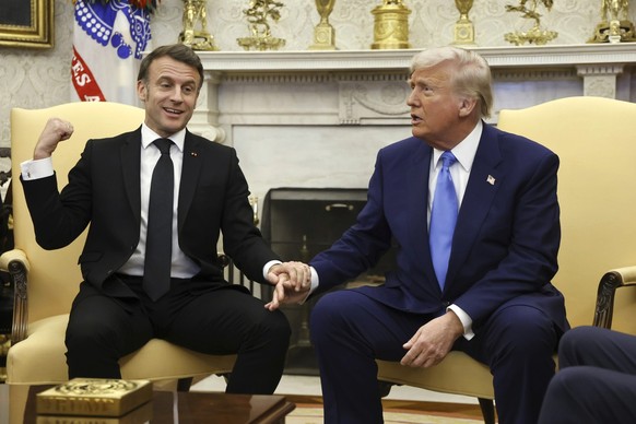 France's President Emmanuel Macron and President Donald Trump speak during a meeting in the Oval Office of the White House in Washington, Monday, Feb. 24, 2025. (Ludovic Marin/Pool via AP)