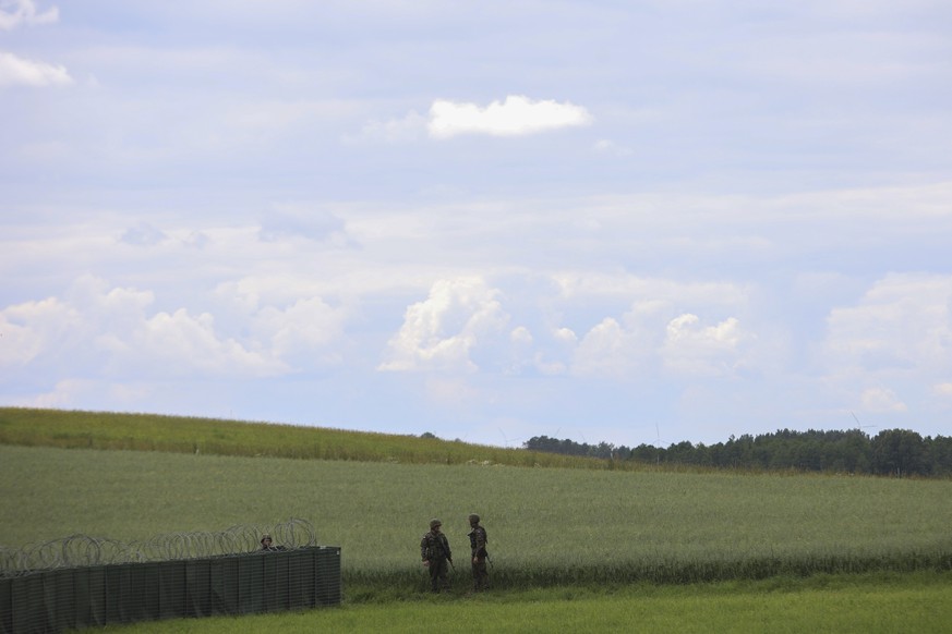Polish soldiers patrol the area prior to a press conference of Polish President Andrzej Duda and Lithuania's President Gitanas Nauseda, near Szypliszki, Poland, Thursday, July 7, 2022. The presid ...