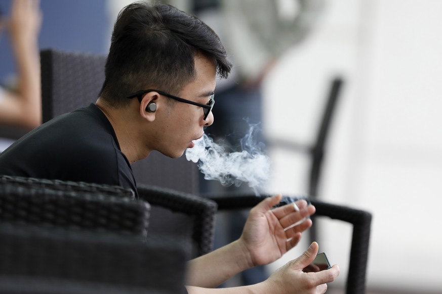 epa09985916 A man smokes in a cafe in Hanoi, Vietnam, 30 May 2022. World No Tobacco Day is observed annually on 31 May since 1987 to raise awareness of the harmful effects of consuming tobacco. EPA/LU ...