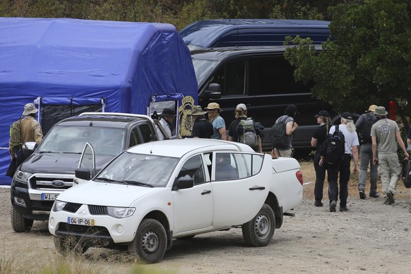 Police search teams arrive back to an operation tent from German and Portuguese registered vehicles near Barragem do Arade, Portugal, Tuesday May 23, 2023. Portuguese police aided by German and Britis ...