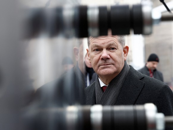 epa10422740 German Chancellor Olaf Scholz is reflected in the surface of technical equipment as he along with French President Emmanuel Macron (not in picture) attends the presentation of Franco-Germa ...