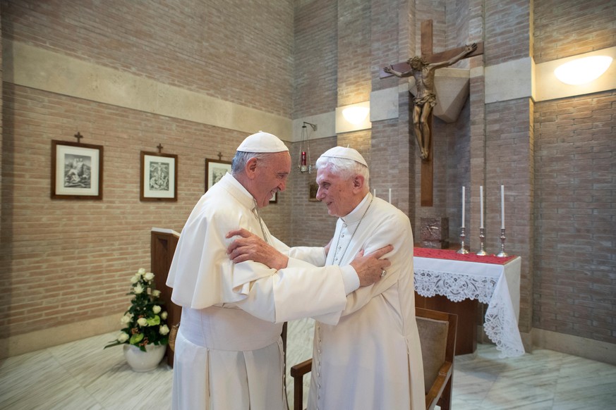 FILE - Pope Francis embraces Pope Emeritus Benedict XVI, right, at the Vatican, on June 28, 2017. Pope Benedict XVI&#039;s 2013 resignation sparked calls for rules and regulations for future retired p ...