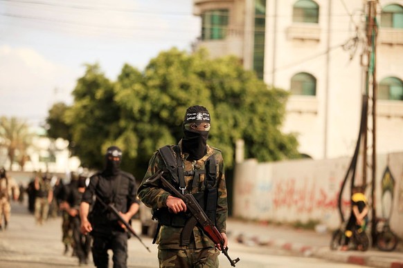 Members of al-Mujahideen brigades, the military wing of al-Mujahideen movement, march during a rally to mark the 14th anniversary of their movement&#039;s founding, on April 24, 2015 in Gaza city.(Pho ...