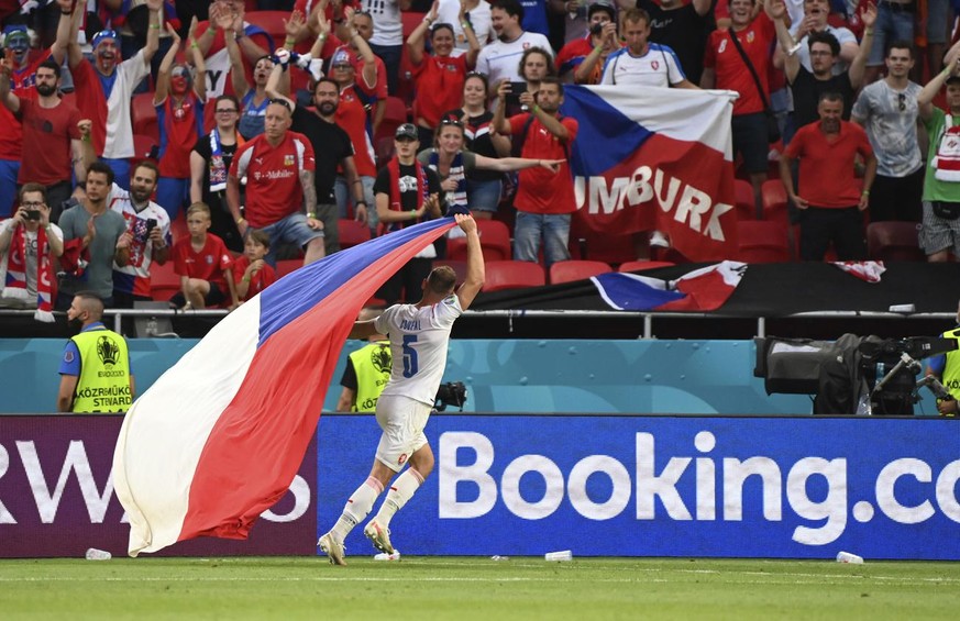 Czech Republic&#039;s Vladimir Coufal holds his national flag as he celebrates winning the Euro 2020 soccer championship round of 16 match between the Netherlands and Czech Republic at the Puskas Aren ...