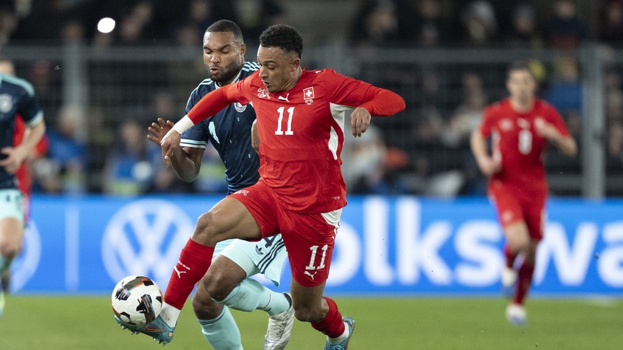 epa12855066 Germany's Jonathan Tah, left, fights for the ball against Switzerland's Dan Ndoye, right, during a friendly soccer match between Switzerland and Germany at the St. Jakob-Park sta ...