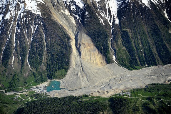 epa12985913 The massive landslide and debris field caused by the collapse of the Birch Glacier, which unleashed tons of rock and ice into the Loetschental valley, pictured one year after the landslide ...