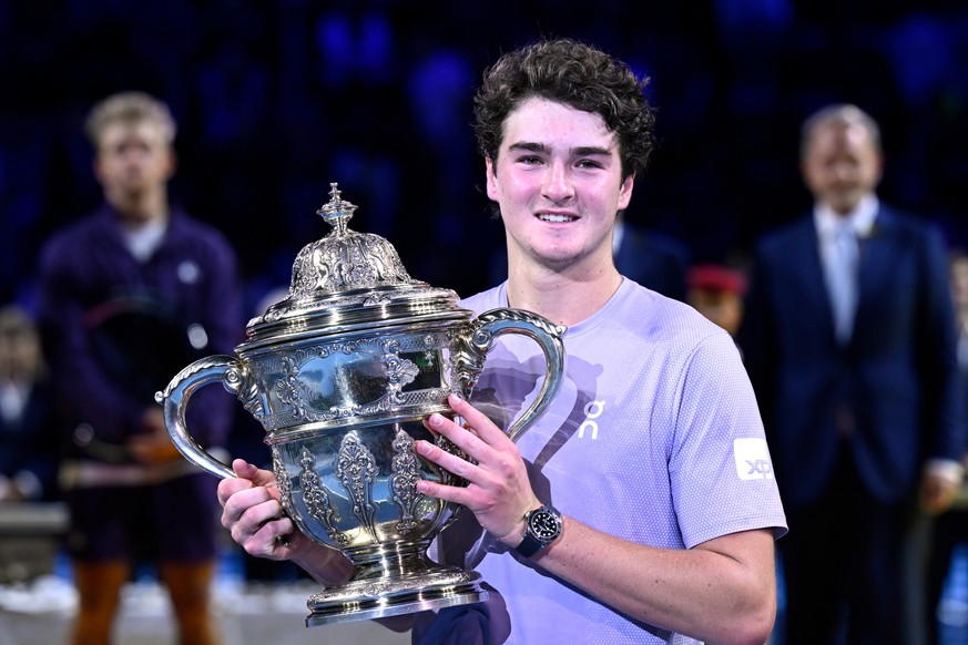 Brazil's Joao Fonseca poses with the trophy after winning the final match against Spain's Alejandro Davidovich Fokina at the Swiss Indoors tennis tournament in Basel, Switzerland, Sunday, Oc ...
