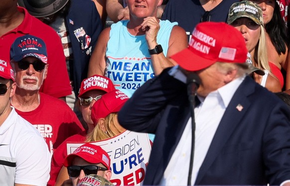 Republican presidential candidate and former U.S. President Donald Trump reacts as multiple shots rang out during a campaign rally at the Butler Farm Show in Butler, Pennsylvania, U.S., July 13, 2024. ...
