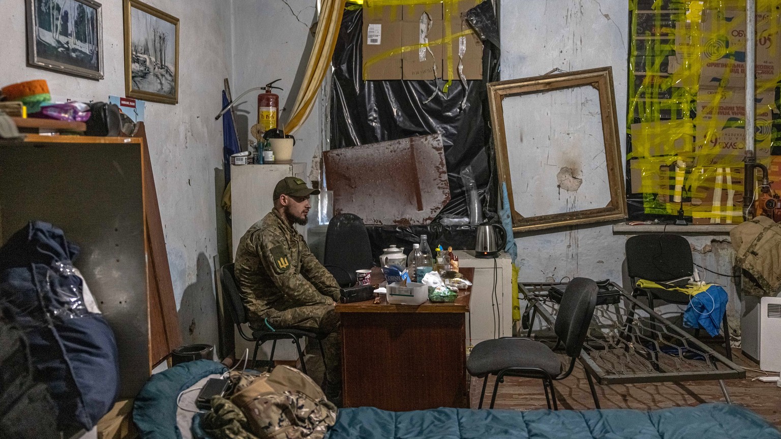 epa09938878 A Ukrainian military medic sits in his room at a frontline field hospital near Popasna, Luhansk region, eastern Ukraine, 09 May 2022 (issued 10 May 2022). On 24 February, Russian troops in ...