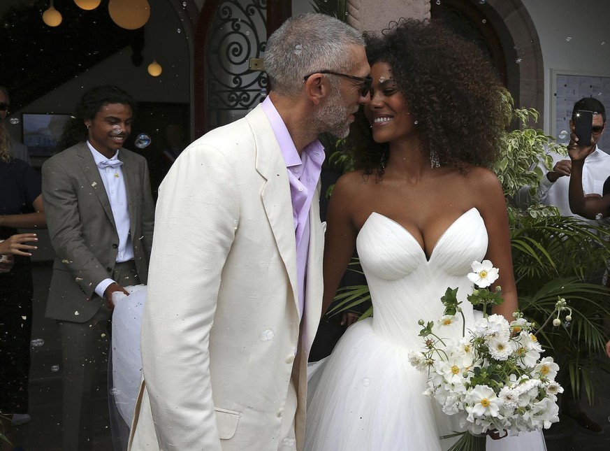 French actor Vincent Cassel and model Tina Kunakey kiss as they leave the town hall after their wedding Friday, Aug. 24, 2018 in Bidart, southwestern France. (AP Photo/Bob Edme)