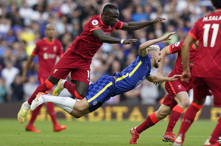 epa09434345 Chelsea���s Jorginho (C) is tackled by Liverpool���s Sadio Mane (L) during the English Premier League match between Liverpool and Chelsea in Liverpool, Britain, 28 August 2021. EPA/ANDREW  ...