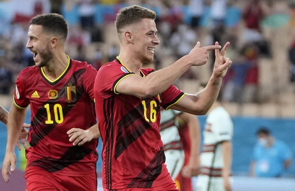Belgium&#039;s Eden Hazard and Belgium&#039;s Thorgan Hazard celebrate after scoring their side&#039;s first goal during the Euro 2020 soccer championship round of 16 match between Belgium and Portuga ...
