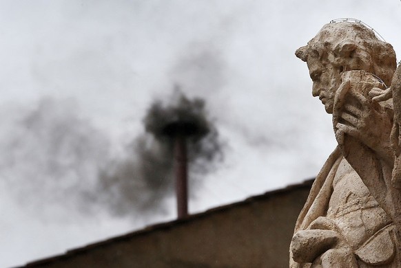 VATICAN CITY, VATICAN - MARCH 13: Black smoke billows from the chimney on the roof of the Sistine Chapel indicating that the College of Cardinals have failed to elect a new Pope on March 13, 2013 in V ...