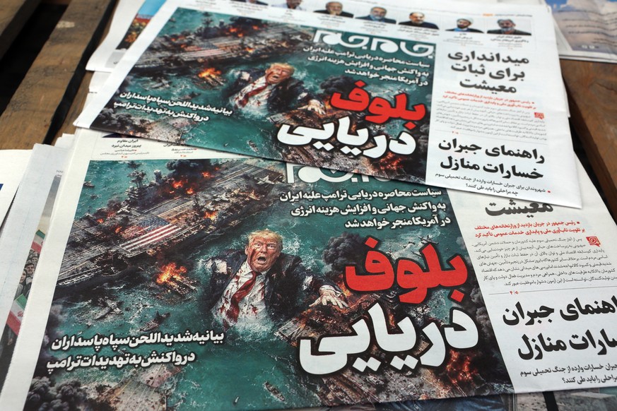 epa12886774 A stack of copies of the Iranian daily newspaper Jame Jam with the headline 'Sea Bluff' is displayed outside a kiosk in Tehran, Tehran, Iran, 13 April 2026. The conflict between  ...