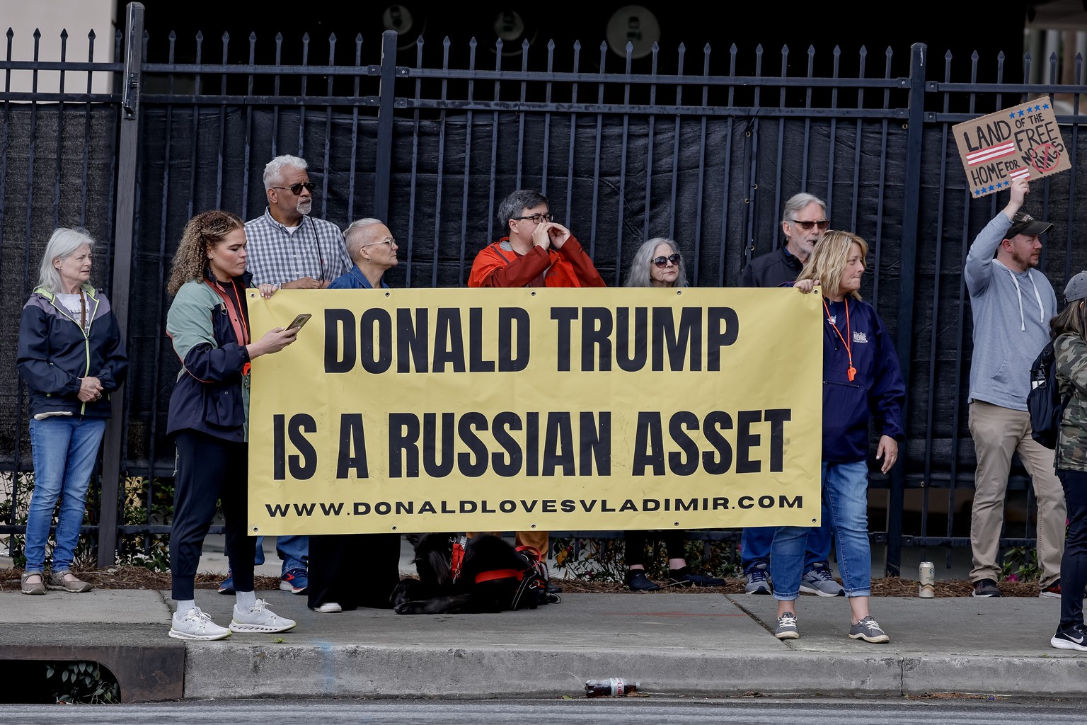 epa12000070 Demonstrators hold placards while participating in a protest against news media coverage of the Trump administration outside of CNN headquarters, in Atlanta, Georgia, USA, 30 March 2025. T ...
