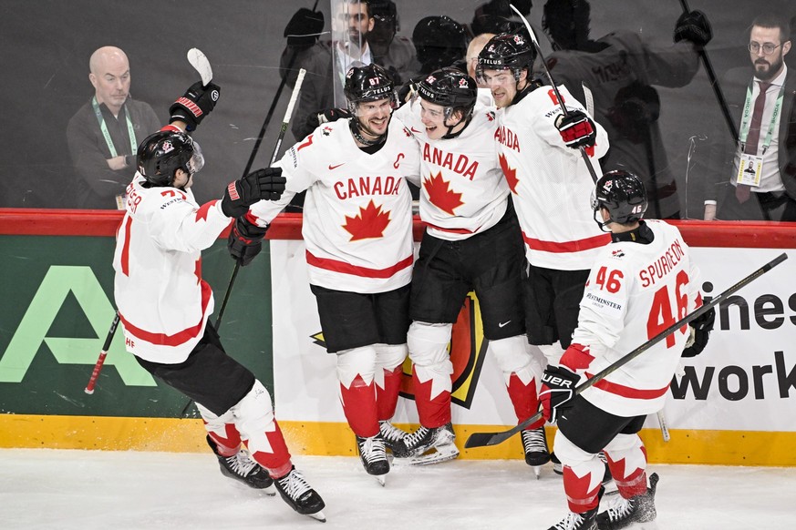 Canada's Macklin Celebrini, center, celebrates scoring with teammates during the IIHF Ice Hockey World Championship group A match between Sweden and Canada in Stockholm, Sweden, Tuesday, May 20,  ...