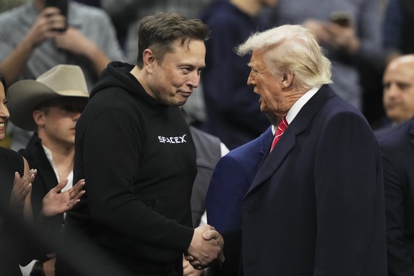 Elon Musk, left, shakes hands with President Donald Trump at the finals for the NCAA wrestling championship, Saturday, March 22, 2025, in Philadelphia. (AP Photo/Matt Rourke)
NCAA Championships Wrestl ...
