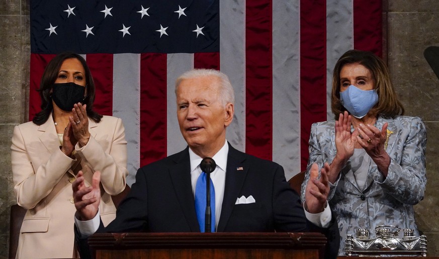 epa09166678 US President Joe Biden addresses a joint session of Congress, with Vice President Kamala Harris and House Speaker Nancy Pelosi (D-Calif.) behind him, at the Capitol in Washington, DC, USA, ...