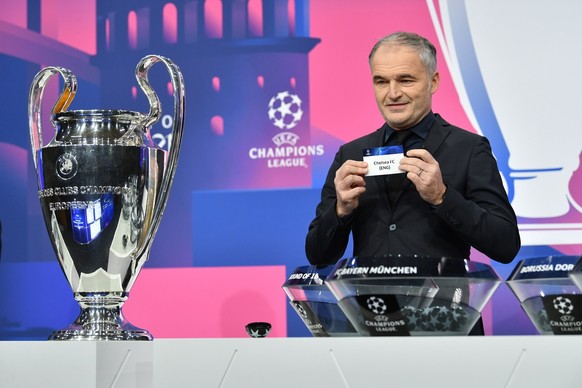 epa08883440 A handout photo made available by UEFA shows Special guest Stephane Chapuisat draws out the card of Chelsea during the UEFA Champions League 2020/21 Round of 16 draw at the UEFA Headquarte ...