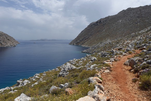 epa11396350 A view showing the path that leads from the beach of Agios Nikolaos to the settlement of Pedi, in Simi island, Greece, 07 June 2024. Search efforts are in full progress, including investig ...
