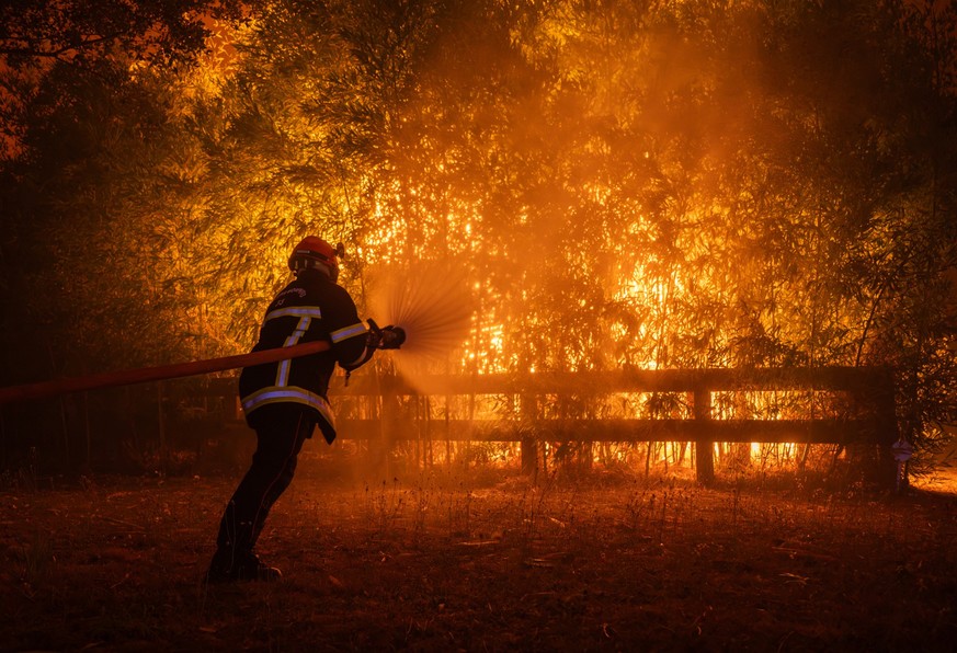 epa13133450 A handout photo made available by SDIS33 (Gironde Departmental Fire and Rescue Service) shows a firefighting crew being deployed to battle a wildfire spreading in Ares, south-western Franc ...
