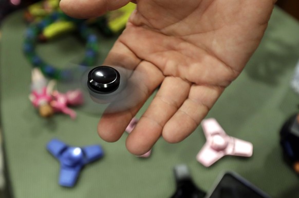 FILE - Funky Monkey Toys store owner Tom Jones plays with a fidget spinner in Oxford, Mich, Thursday, May 11, 2017. (AP Photo/Carlos Osorio, File)
Labubu Blockbuster Toys