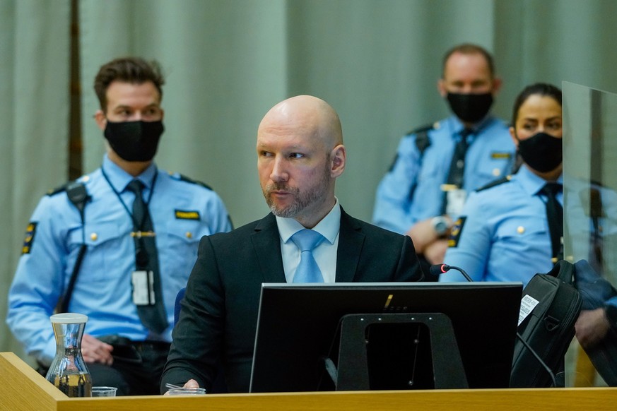 epa09694517 Anders Behring Breivik, convicted of terrorism, sits in the makeshift courtroom in Skien prison on the second day of his parole hearing, in Skien, Norway, 19 January 2022. Mass murderer An ...