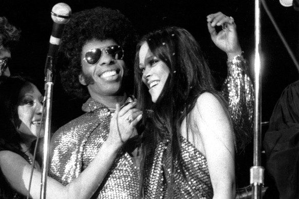 FILE - Sylvester &quot;Sly&quot; Stewart and his bride Kathy Silva, right, are congratulated during their wedding ceremony at a rock concert by Sly and the Family Stone at New York&#039;s Madison Squa ...