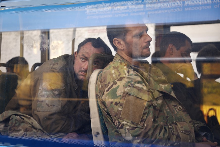 FILE - Ukrainian servicemen sit in a bus after they were evacuated from the besieged Mariupol&#039;s Azovstal steel plant, near a remand prison in Olyonivka, in territory under the government of the D ...