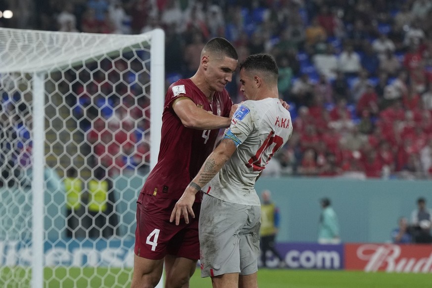 Serbia&#039;s Nikola Milenkovic, left, pushes Switzerland&#039;s Granit Xhaka during the World Cup group G soccer match between Serbia and Switzerland, in Doha, Qatar, Friday Dec. 2, 2022. (AP Photo/R ...