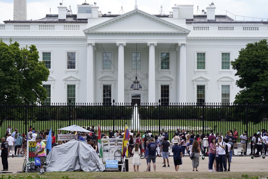 People gather on a section of Pennsylvania Avenue that was reopened to the public in front of the White House, Sunday, July 4, 2021, in Washington. (AP Photo/Patrick Semansky)