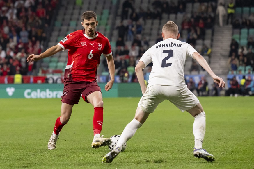 Switzerland&#039;s Adrian Bajrami, left, and Slovenia&#039;s Zan Karnicnik, right, fight for the ball during the FIFA World Cup 26 UEFA Qualifiers Group B match between Slovenia and Switzerland, at St ...