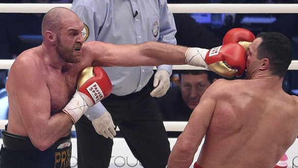 Britain&#039;s Tyson Fury, left, punches Ukraine&#039;s Wladimir Klitschko and in a world heavyweight title fight for Klitschko&#039;s WBA, IBF, WBO and IBO belts in the Esprit Arena in Duesseldorf, w ...