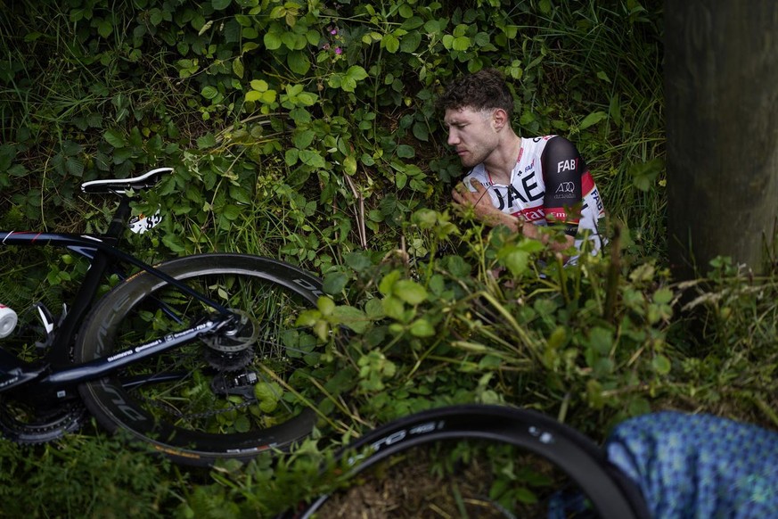 Switzerland&#039;s Marc Hirschi lies on the side of the road after crashing during the first stage of the Tour de France cycling race on June 26, 2021. (AP Photo/Daniel Cole)