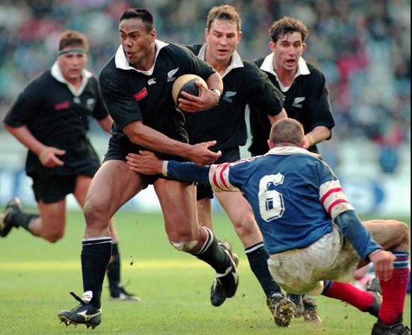 In this Saturday, Nov. 18, 1995 file photo, New Zealand All Blacks winger Jonah Lomu, breaks the tackle of France&#039;s Philippe Benetton right, during their rugby test match at Parc des Princes stad ...
