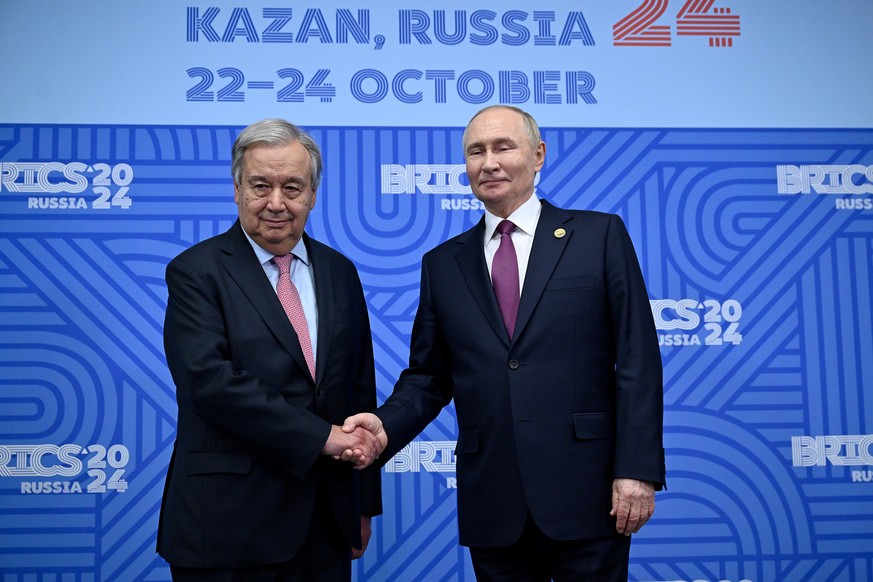 Russian President Vladimir Putin, right, greets United Nations (UN) Secretary General Antonio Guterres during their bilateral meeting on the sidelines of the BRICS summit in Kazan, Russia, Thursday, O ...
