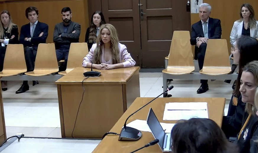 epa10985775 A handout video grab photo from the institutional video signal made available by the Superior Court of Justice of Catalonia (TSJC) shows Colombian singer Shakira (C) testifying at Barcelon ...