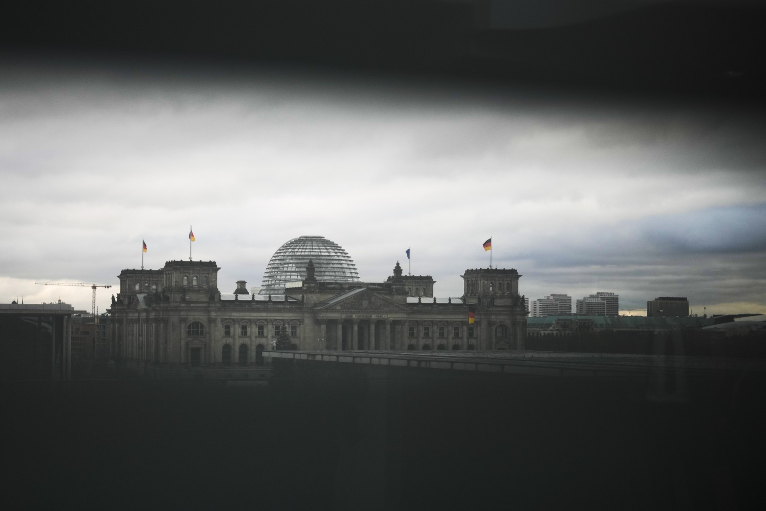 The German parliament Bundestag building, the Reichstag Building photographed through a slit in a blind at the chancellery in Berlin, Germany, Wednesday, Dec. 7, 2022. Officials say thousands of polic ...