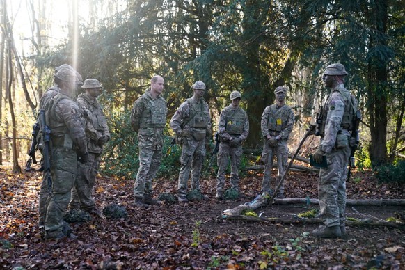 SALISBURY, ENGLAND - NOVEMBER 23: Prince William, Prince of Wales, Colonel-in-Chief, 1st Battalion Mercian Regiment (L) listens to a briefing ahead of an attack exercise during a visit to the regiment ...