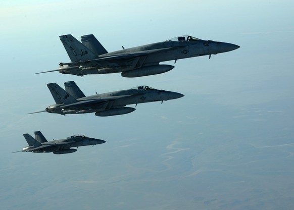 epa04416226 A handout picture made available by the US Department of Defense (DoD) on 25 September 2014 shows a formation of US Navy F-18E Super Hornets leaving after receiving fuel from a KC-135 Stra ...