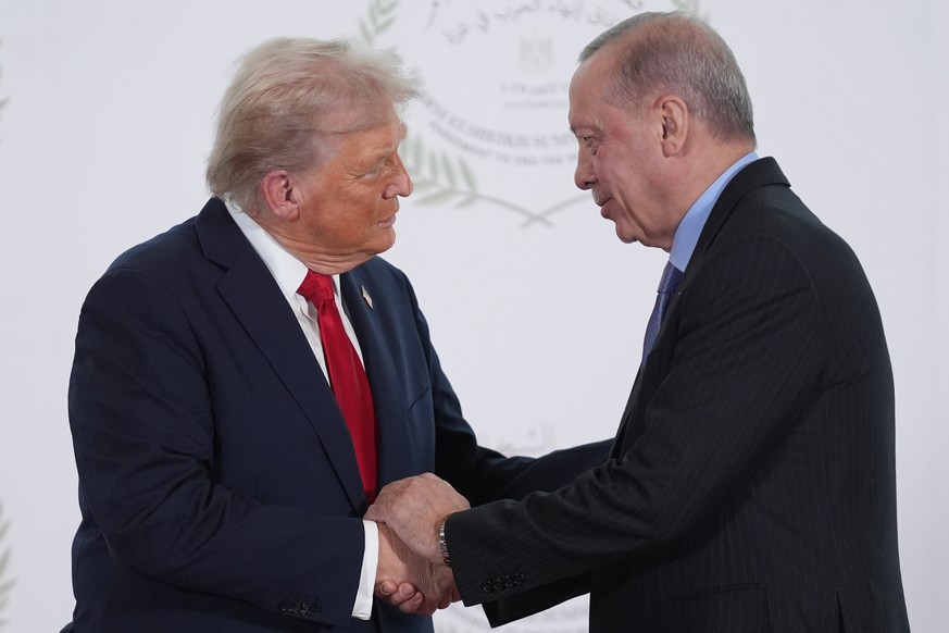 President Donald Trump greets Turkey's President Recep Tayyip Erdogan during a summit to support ending the more than two-year Israel-Hamas war in Gaza after a breakthrough ceasefire deal, Monday ...