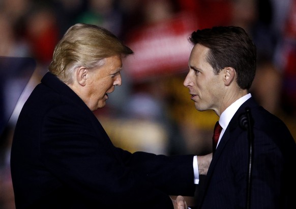 FILE - President Donald Trump listens as Republican Senate candidate Josh Hawley speaks during a campaign rally at Columbia Regional Airport, Thursday, Nov. 1, 2018, in Columbia, Mo. A federal lawsuit ...