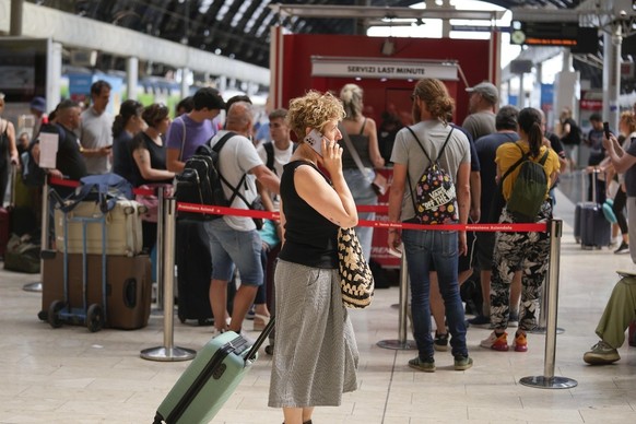 Passengers queue at a Trenitalia ticket office at Milan central station during a national train strike, Thursday, July 13, 2023. Trenitalia and Italo train workers are on strike to demand better worki ...