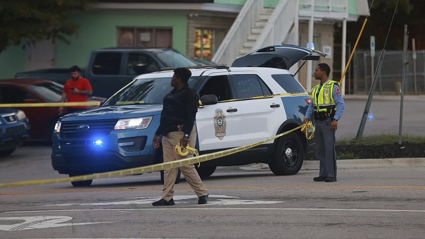 Law enforcement officers block off Old Milburnie Road during a shooting in Raleigh, N.C., Thursday, Oct. 13, 2022. (Ethan Hyman/The News &amp; Observer via AP)