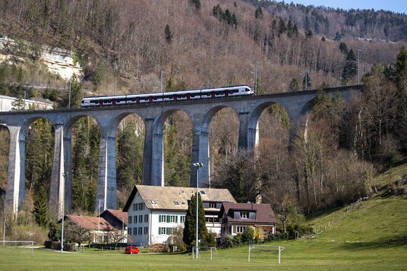 Un train des CFF/SBB circule sur le viaduc de la Combe Maran le samedi 4 avril 2020 a Saint-Ursanne dans le Jura. (KEYSTONE/Jean-Christophe Bott)