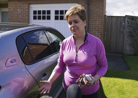 Former first minister of Scotland Nicola Sturgeon speaks to reporters outside her home in Uddingston, Glasgow, Friday April 19, 2024. The SNP has been urged to cooperate with the police investigation  ...