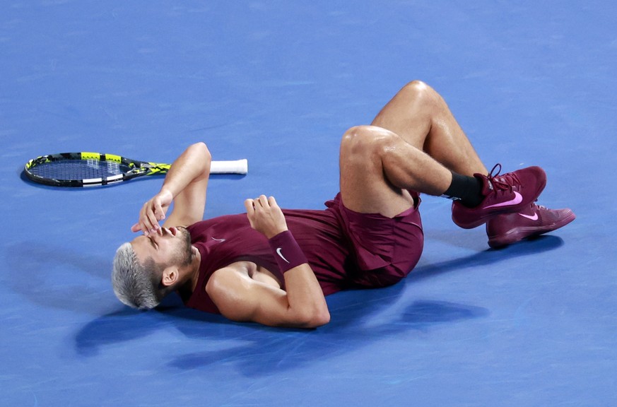 epa12404266 Carlos Alcaraz from Spain is lying on the court after an ankle injury during his round of 32 match of the Japan Open tennis tournament against Sebastian Baez of Argentina at Ariake Colosse ...